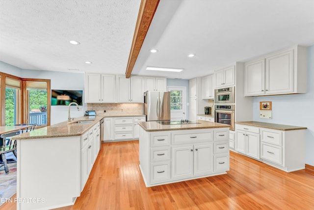 127 Newhaven Rd, Oak Ridge, TN 37830 - kitchen featuring stainless steel appliances, light wood-type flooring, a peninsula, white cabinetry, and light stone counters