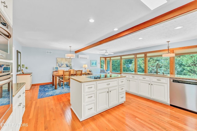 127 Newhaven Rd, Oak Ridge, TN 37830 - kitchen featuring appliances with stainless steel finishes, light wood finished floors, recessed lighting, an AC wall unit, and white cabinets