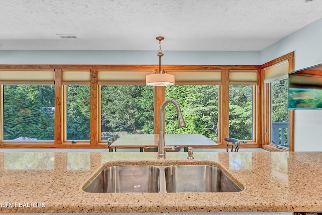127 Newhaven Rd, Oak Ridge, TN 37830 - kitchen with light stone countertops, a textured ceiling, and decorative light fixtures