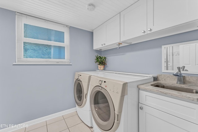 127 Newhaven Rd, Oak Ridge, TN 37830 - laundry area with cabinet space, washer and clothes dryer, and light tile patterned floors