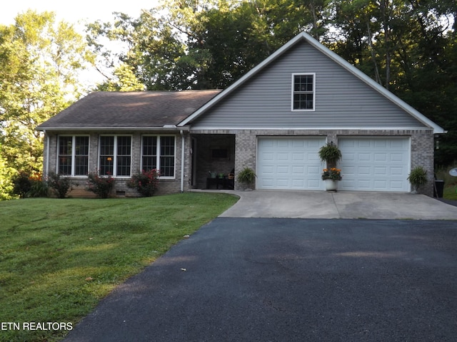 440 Sams Mtn, Middlesboro, KY 40965 - view of front of home featuring asphalt driveway, brick siding, and a front lawn