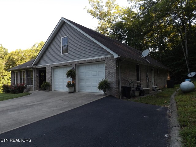 440 Sams Mtn, Middlesboro, KY 40965 - view of front of property with driveway, brick siding, and a garage