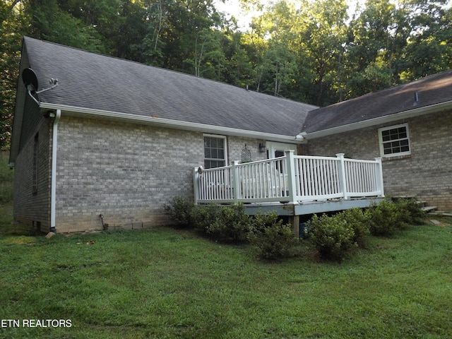 440 Sams Mtn, Middlesboro, KY 40965 - rear view of property with brick siding, a wooden deck, a lawn, and roof with shingles