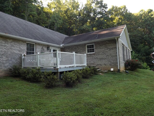 440 Sams Mtn, Middlesboro, KY 40965 - back of house with brick siding, a wooden deck, a lawn, and a shingled roof