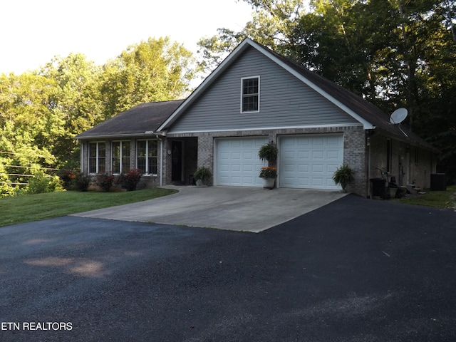 440 Sams Mtn, Middlesboro, KY 40965 - view of front of property featuring driveway, brick siding, a garage, and a front lawn