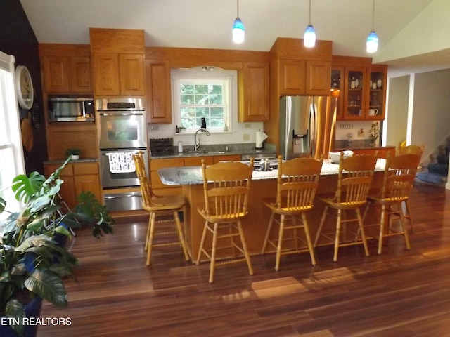 440 Sams Mtn, Middlesboro, KY 40965 - kitchen with stainless steel appliances, a warming drawer, brown cabinets, dark wood-style flooring, and glass insert cabinets