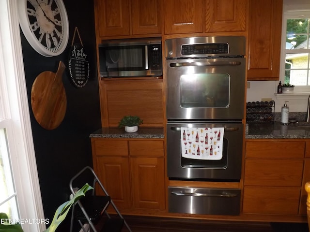 440 Sams Mtn, Middlesboro, KY 40965 - kitchen featuring stainless steel double oven, a warming drawer, refrigerator, and brown cabinets