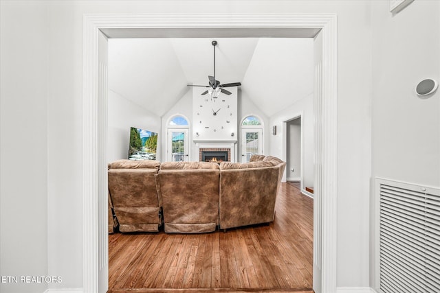 1036 Circle Dr, Jamestown, TN 38556 - living area featuring a ceiling fan, wood finished floors, a fireplace, and high vaulted ceiling