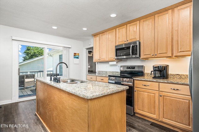 1036 Circle Dr, Jamestown, TN 38556 - kitchen with stainless steel appliances, dark wood-style flooring, a kitchen island with sink, light stone countertops, and recessed lighting
