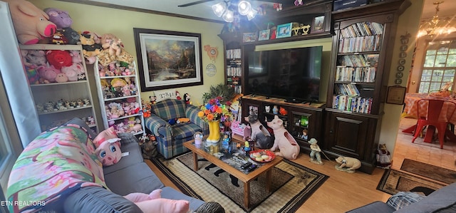 191 Ashley Ln, Oneida, TN 37841 - living area with wood finished floors, a chandelier, crown molding, and a ceiling fan