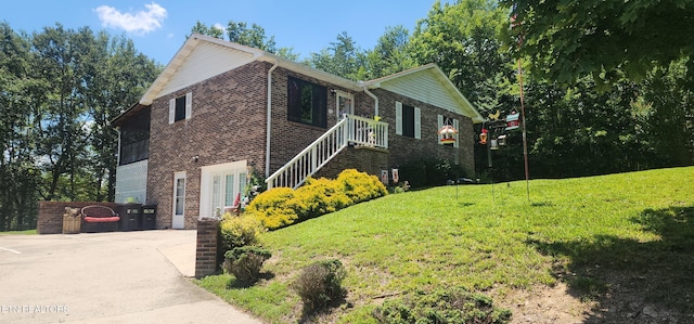 191 Ashley Ln, Oneida, TN 37841 - view of home's exterior featuring brick siding and a yard