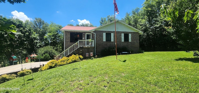 191 Ashley Ln, Oneida, TN 37841 - ranch-style house with brick siding, a front lawn, a metal roof, and driveway