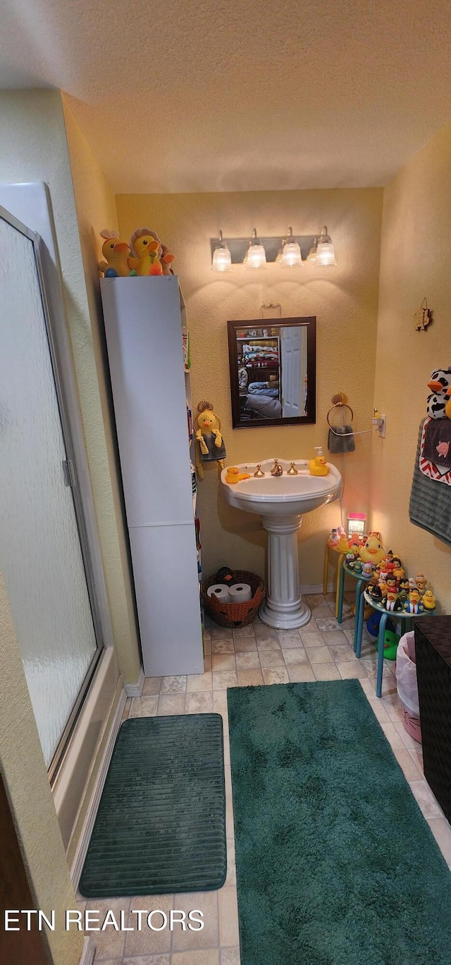 191 Ashley Ln, Oneida, TN 37841 - full bath with tile patterned flooring, a shower with door, and a textured ceiling