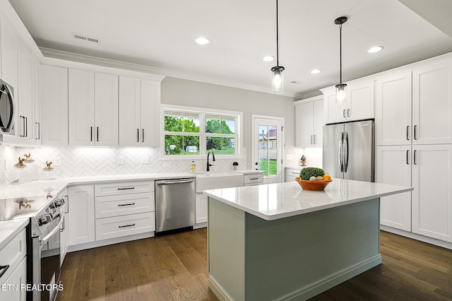 7245 Deville Way, Powell, TN 37849 - kitchen with appliances with stainless steel finishes, backsplash, white cabinetry, a center island, and dark wood-style floors