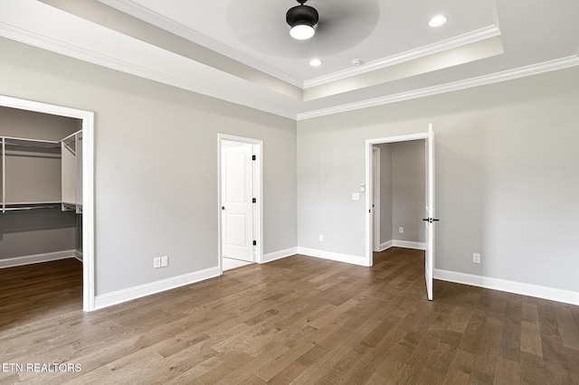 7245 Deville Way, Powell, TN 37849 - unfurnished bedroom with ornamental molding, wood finished floors, a tray ceiling, a walk in closet, and recessed lighting