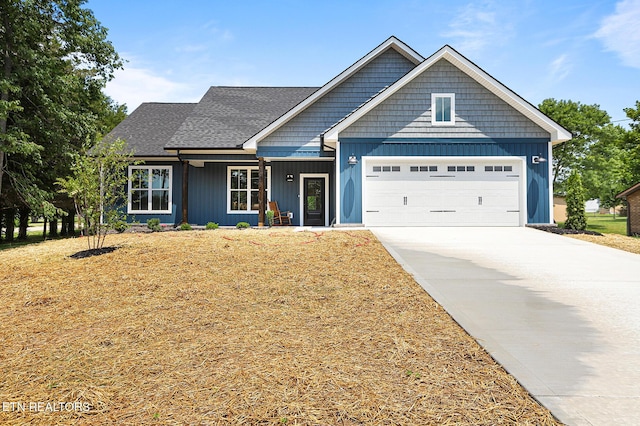 7245 Deville Way, Powell, TN 37849 - view of front of property featuring a garage, concrete driveway, covered porch, and roof with shingles