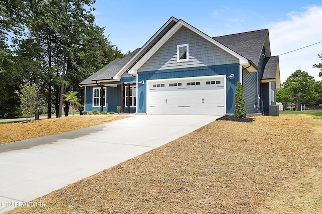 7245 Deville Way, Powell, TN 37849 - view of front of house with a garage, concrete driveway, board and batten siding, and a shingled roof