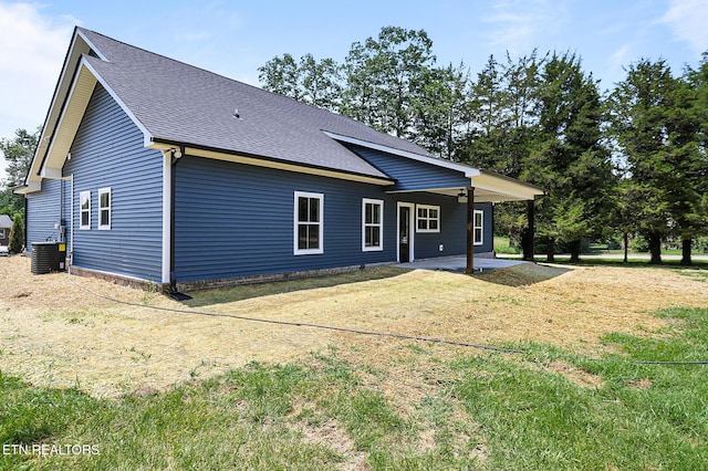 7245 Deville Way, Powell, TN 37849 - back of property featuring a shingled roof, a patio area, and a yard
