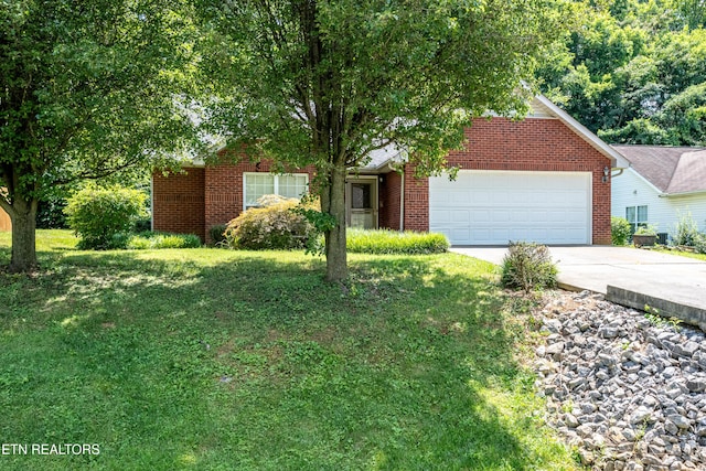 1032 Willow Creek Cir, Maryville, TN 37804 - obstructed view of property featuring an attached garage, concrete driveway, brick siding, and a front yard