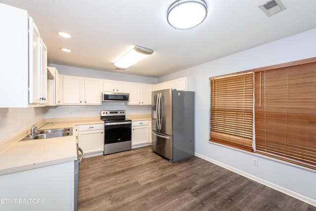 1032 Willow Creek Cir, Maryville, TN 37804 - kitchen with stainless steel appliances, light countertops, dark wood-type flooring, recessed lighting, and white cabinetry