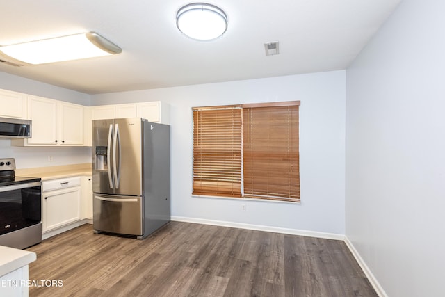 1032 Willow Creek Cir, Maryville, TN 37804 - kitchen with stainless steel appliances, wood finished floors, light countertops, and white cabinetry