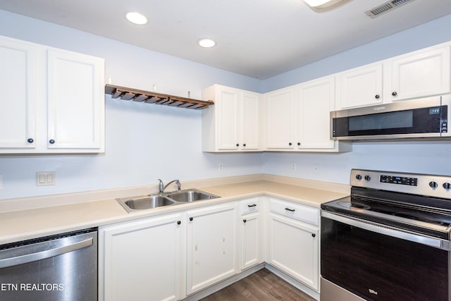 1032 Willow Creek Cir, Maryville, TN 37804 - kitchen featuring appliances with stainless steel finishes, white cabinets, light countertops, recessed lighting, and dark wood-type flooring