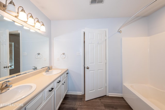 1032 Willow Creek Cir, Maryville, TN 37804 - bathroom featuring double vanity, wood finished floors, and  shower combination