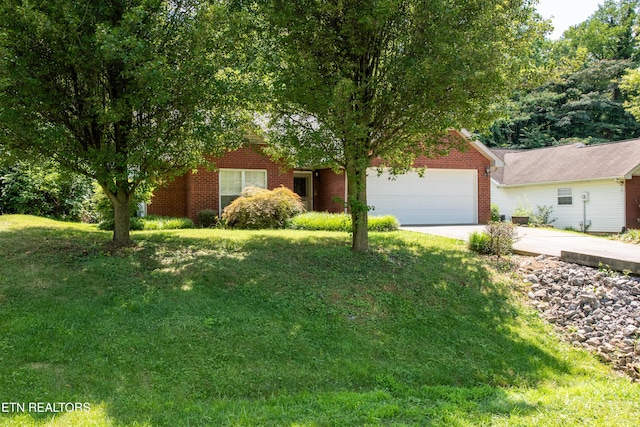 1032 Willow Creek Cir, Maryville, TN 37804 - obstructed view of property featuring a garage, driveway, a front yard, and brick siding