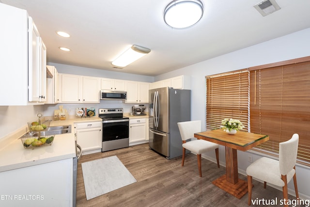 1032 Willow Creek Cir, Maryville, TN 37804 - kitchen with appliances with stainless steel finishes, light countertops, recessed lighting, white cabinetry, and dark wood-style floors