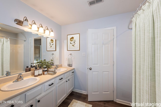 1032 Willow Creek Cir, Maryville, TN 37804 - bathroom with wood finished floors, double vanity, and a shower with shower curtain