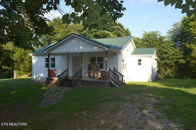 31058 US-127, Pikeville, TN 37367 - bungalow-style house with covered porch, a front yard, and a metal roof
