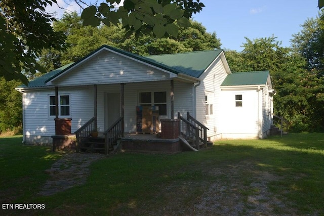 31058 US-127, Pikeville, TN 37367 - view of front facade with a porch, a front lawn, and a metal roof