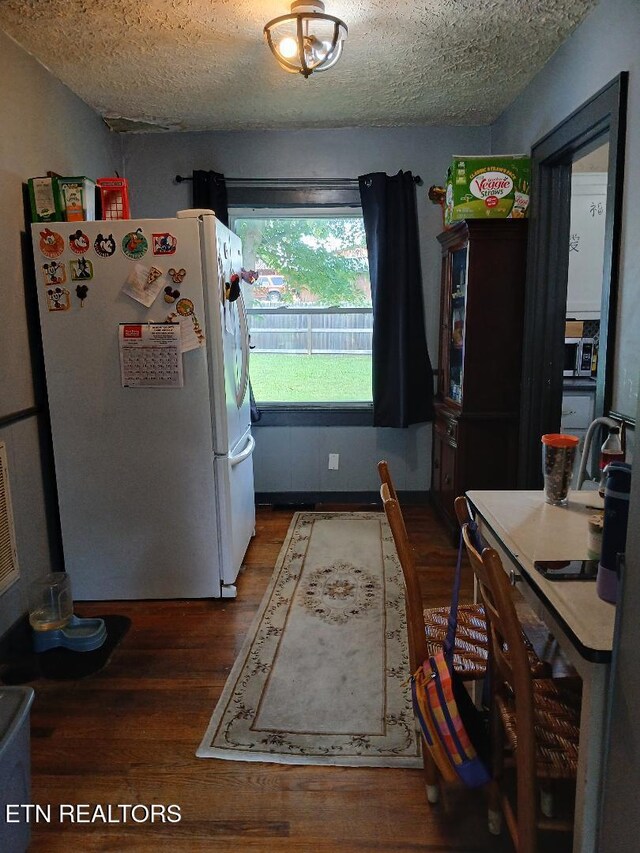 955 Poplar St, Alcoa, TN 37701 - kitchen featuring freestanding refrigerator, a textured ceiling, and wood finished floors