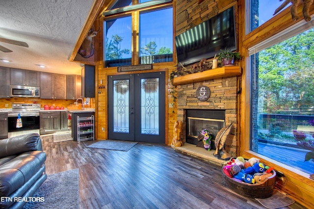 224 Eagle Blf, Jamestown, TN 38556 - living room featuring wine cooler, a ceiling fan, a textured ceiling, wood finished floors, and a stone fireplace