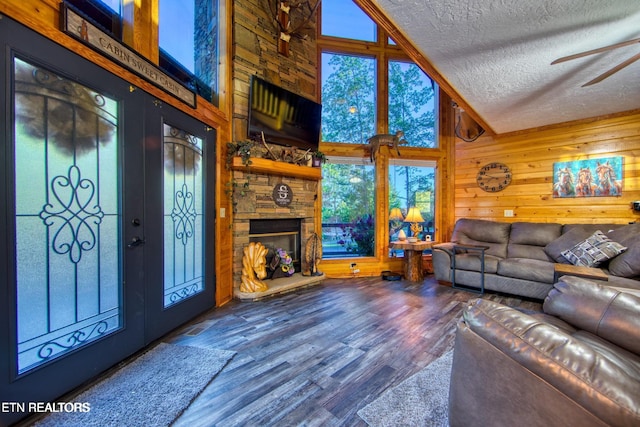 224 Eagle Blf, Jamestown, TN 38556 - living area featuring a textured ceiling, ceiling fan, wood finished floors, wooden walls, and vaulted ceiling
