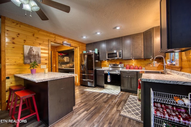 224 Eagle Blf, Jamestown, TN 38556 - kitchen featuring appliances with stainless steel finishes, dark wood-type flooring, a textured ceiling, ceiling fan, and dark brown cabinetry
