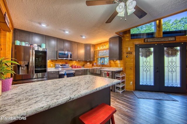 224 Eagle Blf, Jamestown, TN 38556 - kitchen with stainless steel appliances, a peninsula, dark wood-style flooring, french doors, and a ceiling fan