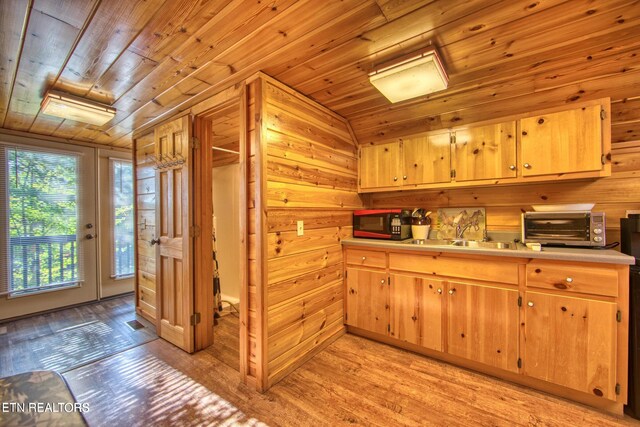 224 Eagle Blf, Jamestown, TN 38556 - kitchen featuring black microwave, wood ceiling, light countertops, wooden walls, and light wood-style floors