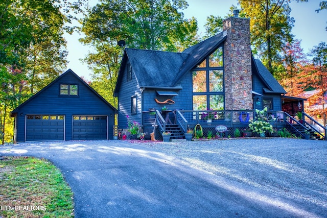 224 Eagle Blf, Jamestown, TN 38556 - rustic home featuring a detached garage, a chimney, roof with shingles, and an outbuilding