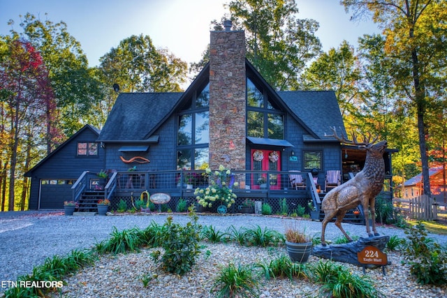 224 Eagle Blf, Jamestown, TN 38556 - view of front of home featuring a garage, a chimney, a shingled roof, and a deck