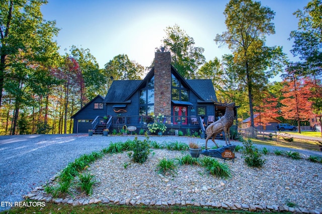 224 Eagle Blf, Jamestown, TN 38556 - rustic home with a garage, a deck, a chimney, and driveway