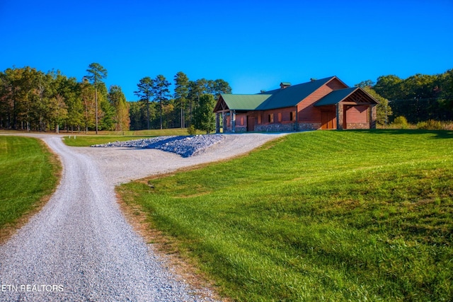 224 Eagle Blf, Jamestown, TN 38556 - view of front facade with driveway, a front yard, stone siding, a chimney, and a forest view