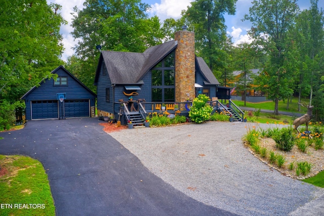 224 Eagle Blf, Jamestown, TN 38556 - rustic home with an outdoor structure, a detached garage, a chimney, a wooden deck, and a shingled roof