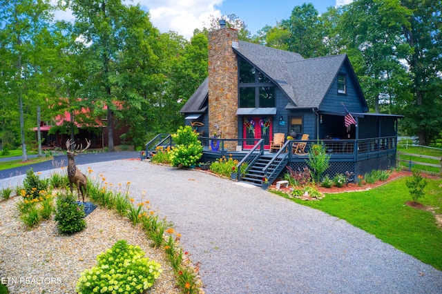 224 Eagle Blf, Jamestown, TN 38556 - rustic home with a shingled roof, a chimney, gravel driveway, and a wooden deck