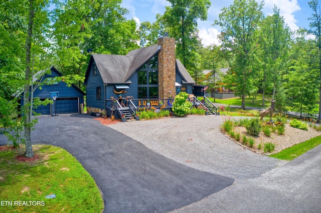 224 Eagle Blf, Jamestown, TN 38556 - view of front of property with a detached garage, an outdoor structure, a chimney, a wooden deck, and a shingled roof