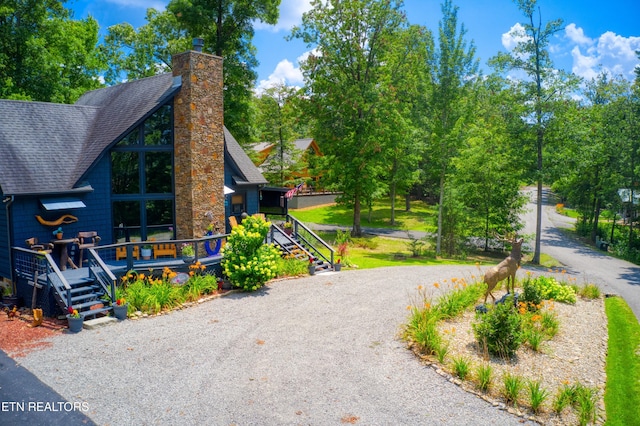 224 Eagle Blf, Jamestown, TN 38556 - view of front of house with roof with shingles, a chimney, and gravel driveway