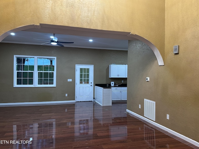 901 Kyle St, Lafollette, TN 37766 - unfurnished living room featuring arched walkways, ceiling fan, dark wood-type flooring, and a textured wall
