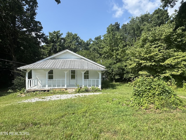 914 S 13th St, Lafollette, TN 37766 - view of front of house with covered porch, a front lawn, and a metal roof