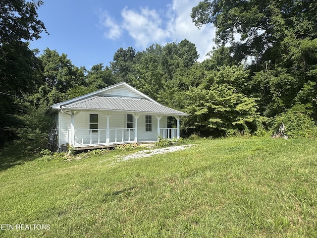 914 S 13th St, Lafollette, TN 37766 - view of front of property with covered porch, a front yard, and a metal roof