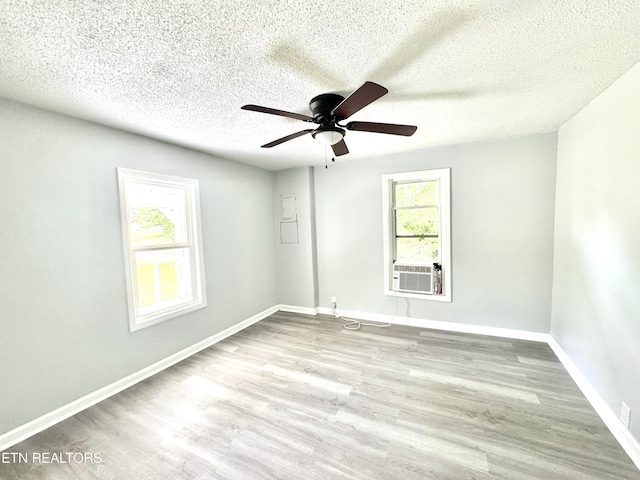 914 S 13th St, Lafollette, TN 37766 - empty room featuring plenty of natural light, ceiling fan, cooling unit, wood finished floors, and a textured ceiling